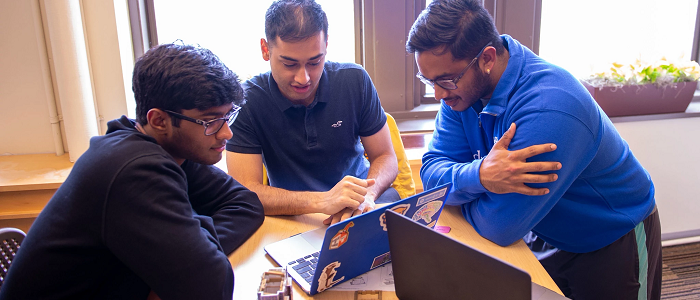 students working together on laptops